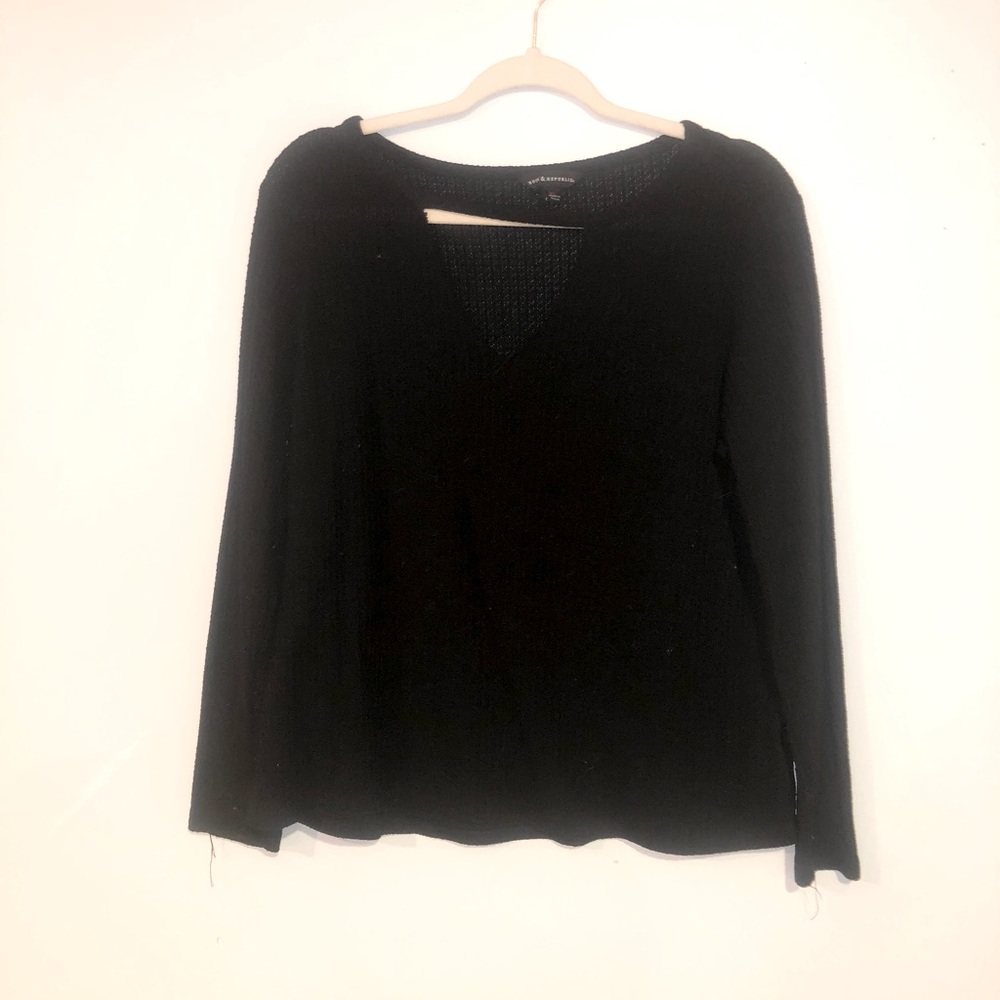 Low cut, black sweater.